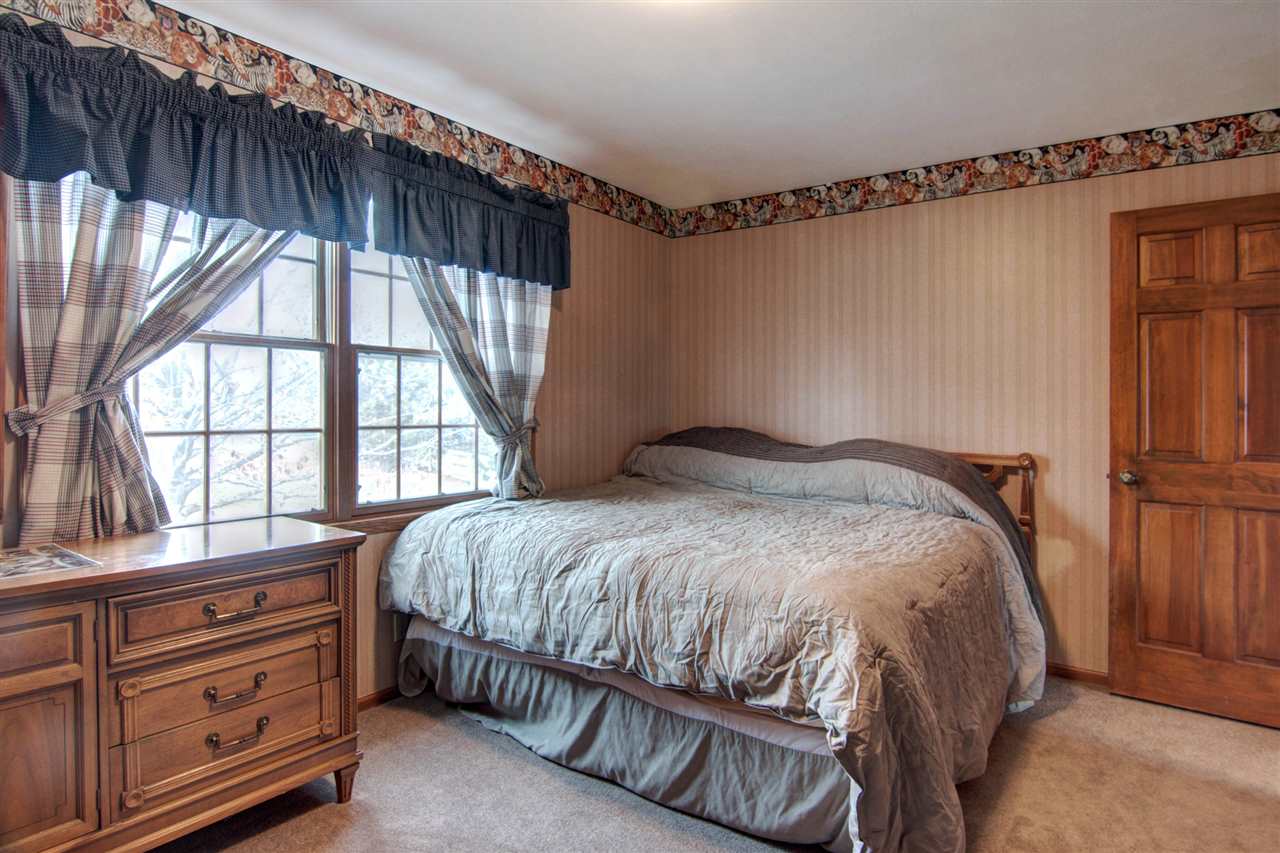 7196 Sentinel Road Rockford, IL 61107 - Photo 15 of 24 a bedroom with a bed and a window