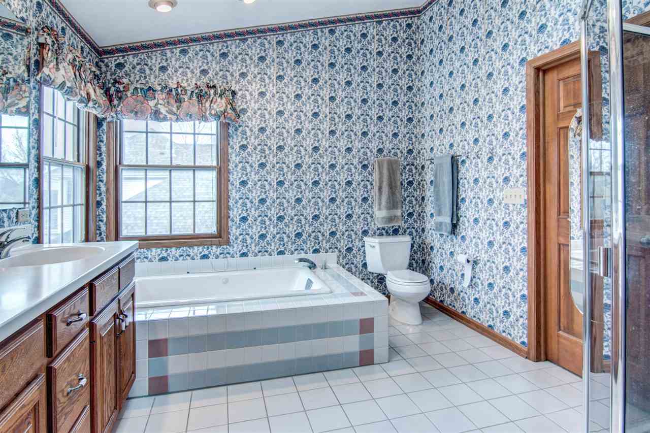 7196 Sentinel Road Rockford, IL 61107 - Photo 16 of 24 a bathroom with a bathtub and a shower