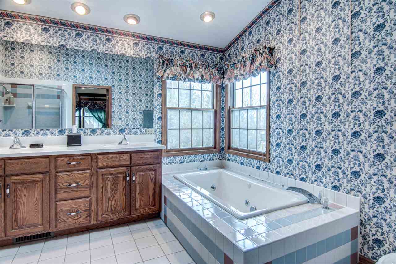 7196 Sentinel Road Rockford, IL 61107 - Photo 17 of 24 a bath tub sitting in a bathroom next to a sink