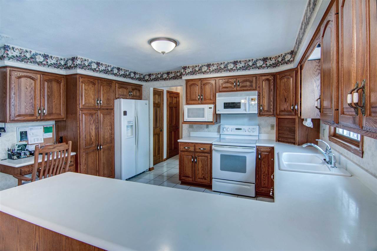7196 Sentinel Road Rockford, IL 61107 - Photo 5 of 24 a kitchen with stainless steel appliances a stove refrigerator sink and cabinets