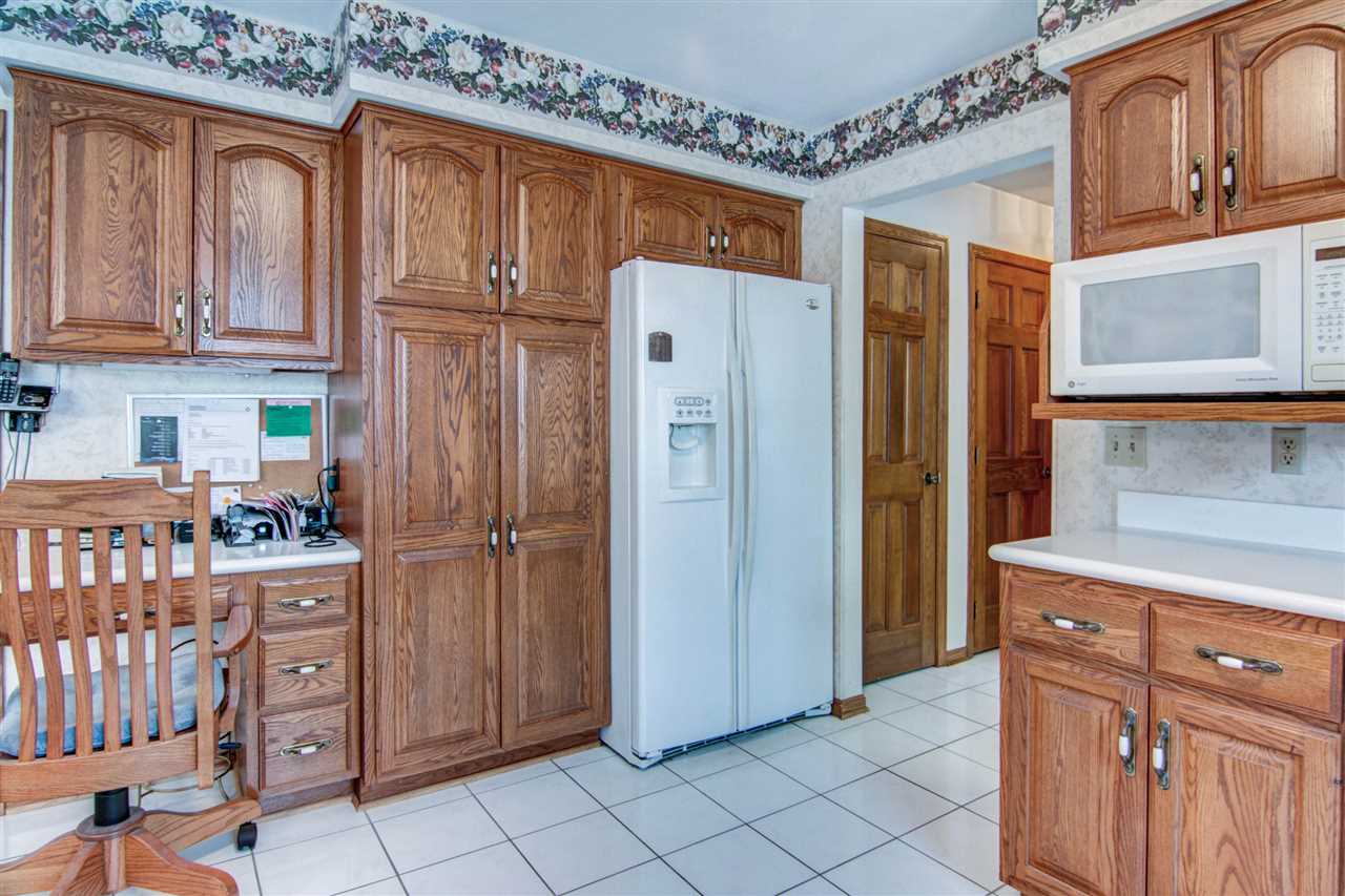 7196 Sentinel Road Rockford, IL 61107 - Photo 7 of 24 a kitchen with stainless steel appliances granite countertop a refrigerator and cabinets