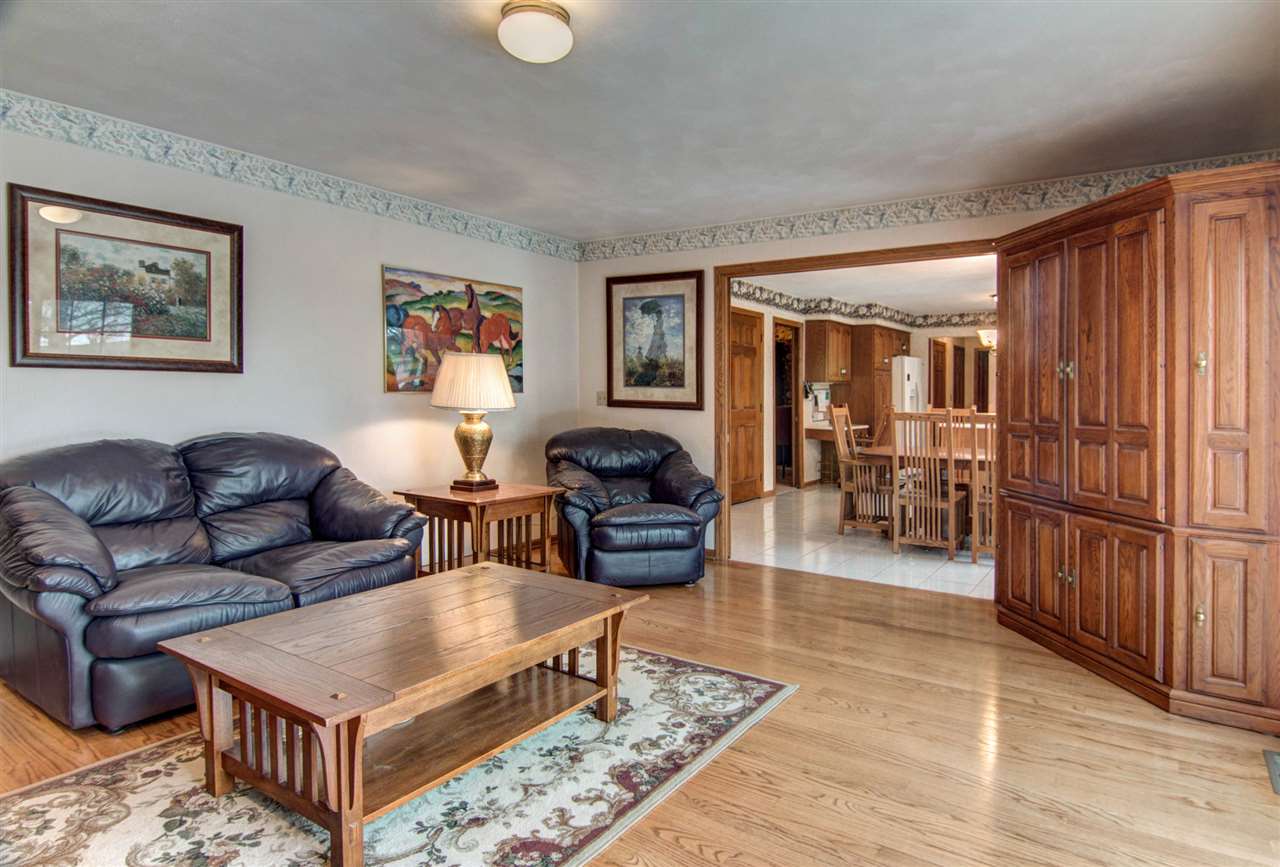 7196 Sentinel Road Rockford, IL 61107 - Photo 8 of 24 a living room with furniture and a wooden floor
