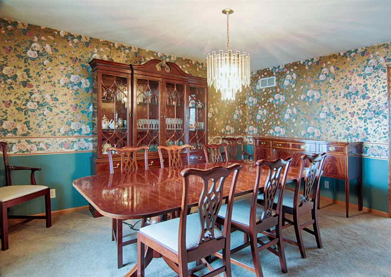 7196 Sentinel Road Rockford, IL 61107 - Photo 10 of 24 a view of a dining room with furniture and chandelier
