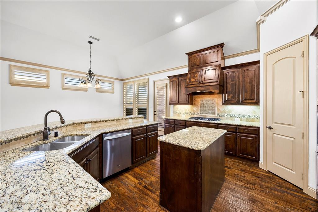 6814 Springwood Lane Garland, TX 75044 - Photo 16 of 35 a kitchen with granite countertop stainless steel appliances sink stove and refrigerator