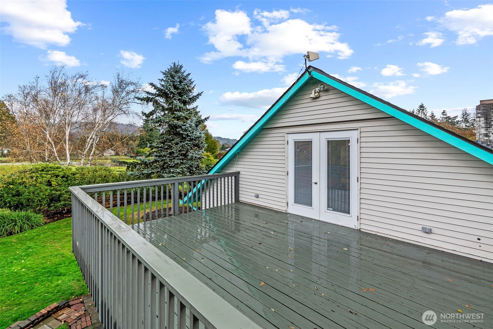 10 Lee Place Longview, WA 98632 - Photo 24 of 27 a balcony with wooden floor and trees in the background