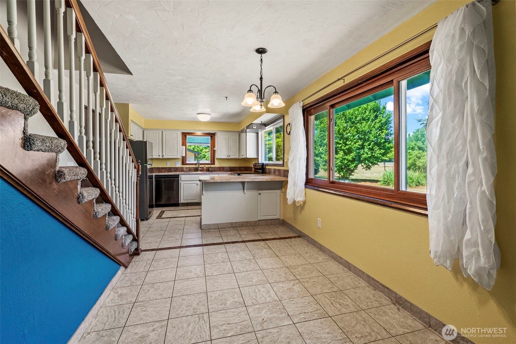 10 Lee Place Longview, WA 98632 - Photo 7 of 27 a kitchen with a stove a refrigerator and white cabinets