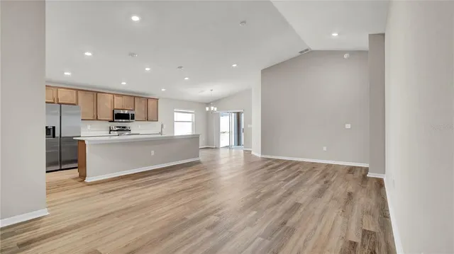 a view of kitchen with wooden floor and electronic appliances