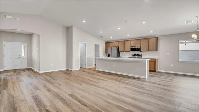 a kitchen with kitchen island a sink stainless steel appliances and cabinets