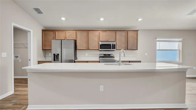 a view of kitchen with furniture and wooden floor