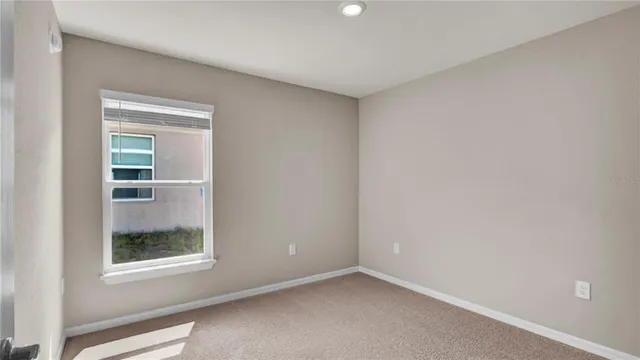 an empty room with windows and closet