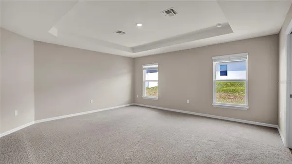an empty room with windows and closet