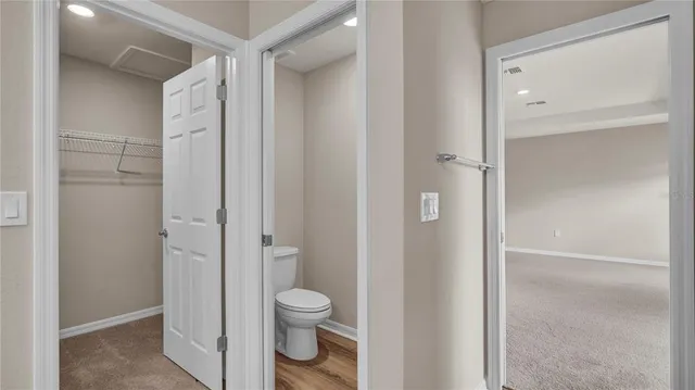 a view of a house with a yard and potted plants