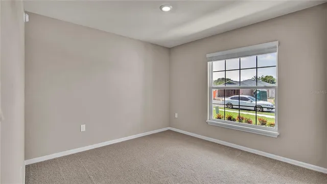 a view of an empty room and closet area
