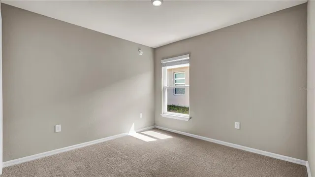 a view of kitchen with kitchen island wooden floor granite counter tops and white cabinets