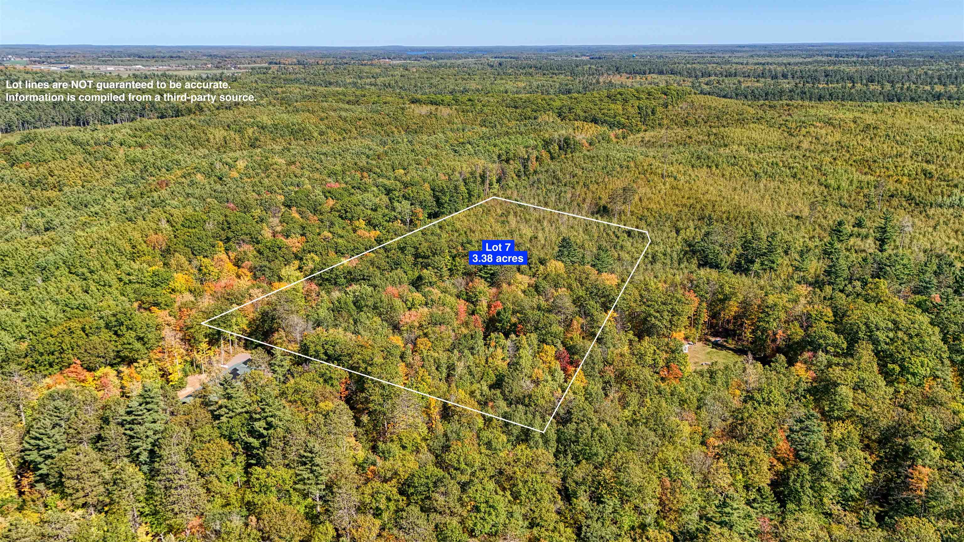 Aerial view of property and surrounding area with property parcel outlined