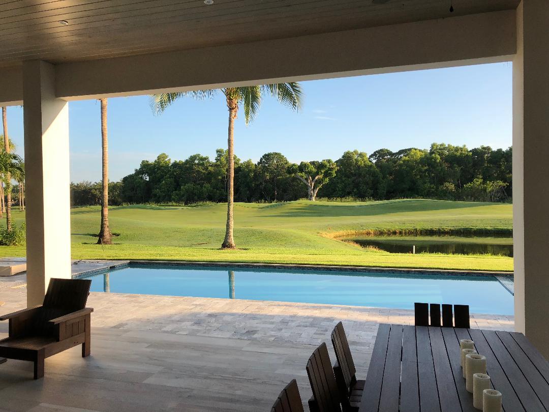 7140 Queenferry Circle Boca Raton, FL 33496 - Photo 13 of 51 a view of swimming pool with a table and chair under an umbrella