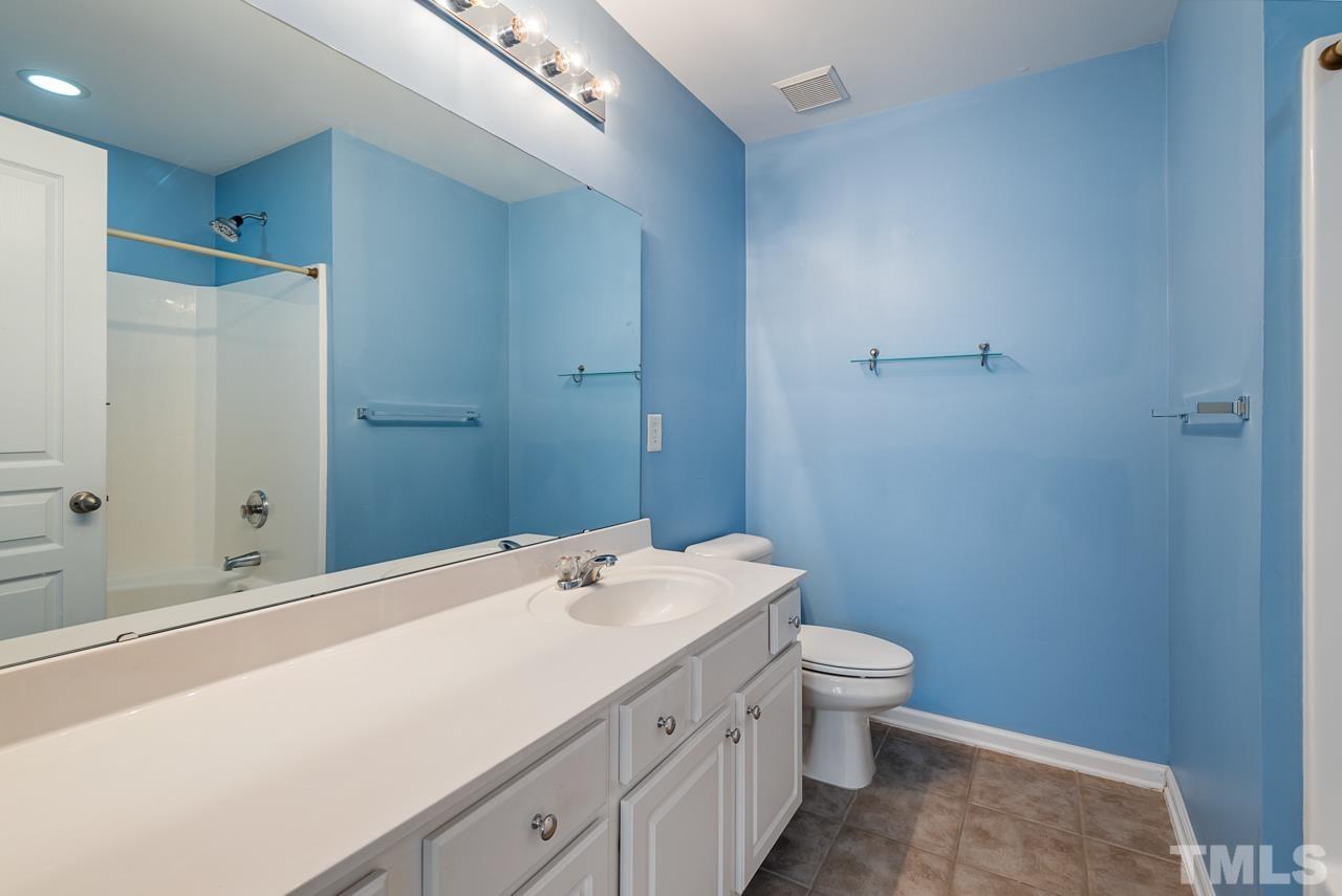 7892 Spungold Street Raleigh, NC 27617 - Photo 33 of 45 a bathroom with a sink a toilet and shower