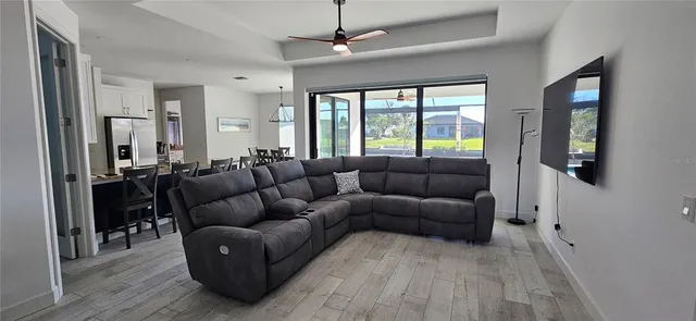 a living room with furniture and a large window