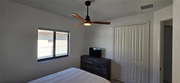 a bedroom with a bed and a window