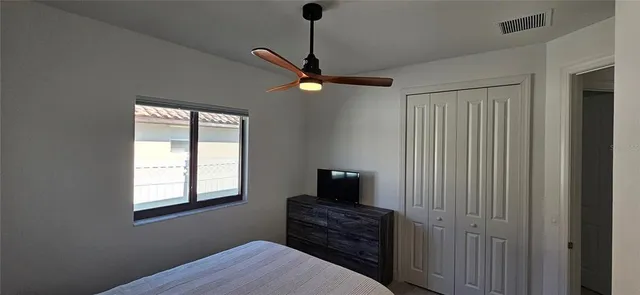 a bedroom with a bed and a window