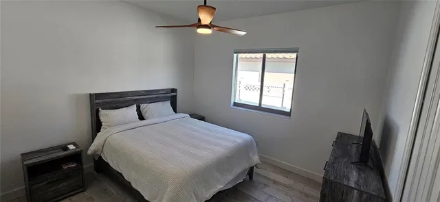 a bedroom with a bed and a window