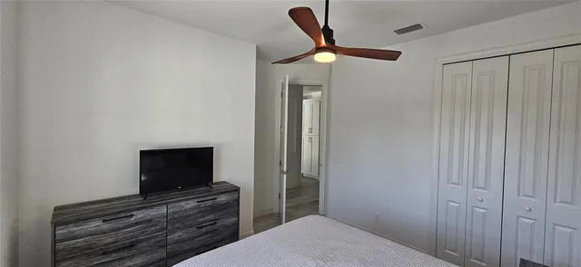 a bedroom with a bed and a television