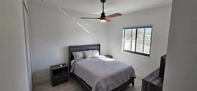 a bedroom with a bed a window and closet