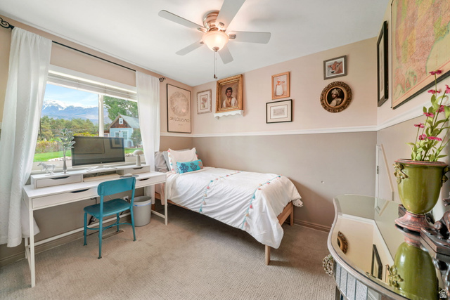 357 South 320 W Street Lindon, UT 84042 - Photo 16 of 41 Bedroom featuring a large window, neutral carpeting, a ceiling fan with integrated lighting, and crown molding