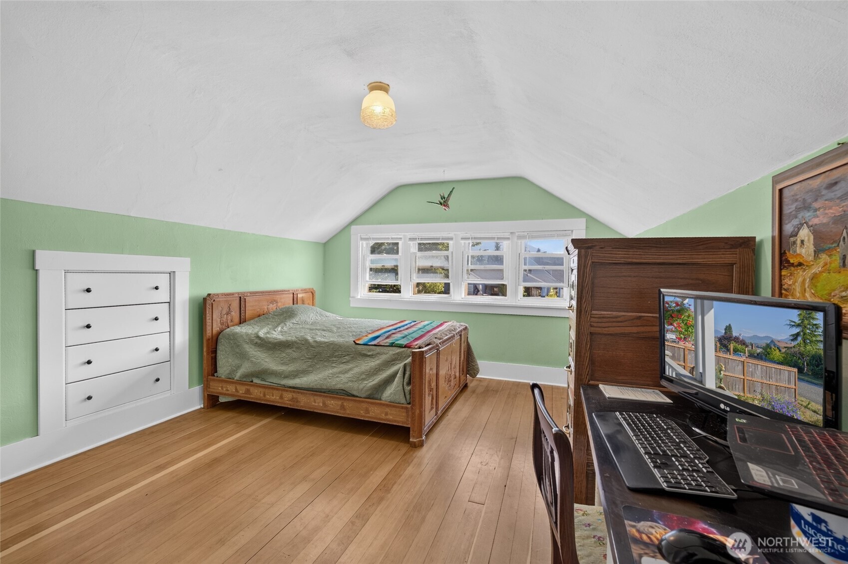 237 West 3rd Street Port Angeles, WA 98362 - Photo 28 of 40 a spacious bedroom with a bed and a window