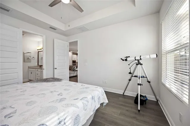 a spacious bathroom with a granite countertop sink mirror and shower
