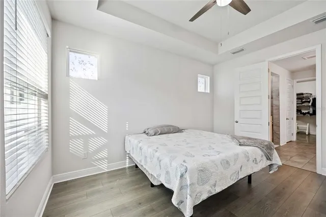 a spacious bathroom with a granite countertop sink mirror and shower