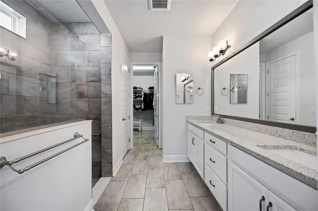 a view of walk in closet with clothes and shoes