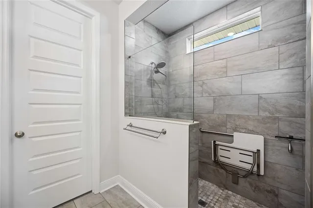 a very nice looking room with many windows and furniture