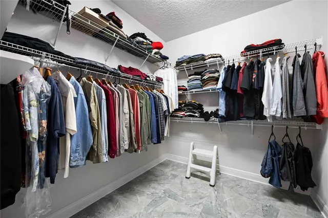 a bathroom with a granite countertop sink toilet mirror and shower