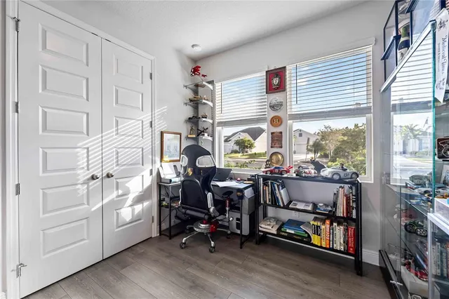 a bedroom with furniture and large windows