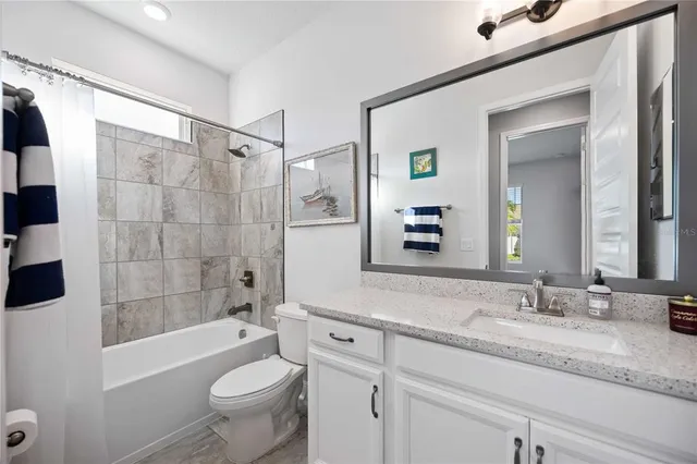 an aerial view of a house with a yard basket ball court and outdoor seating