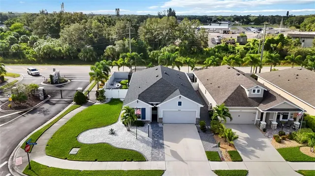 an aerial view of residential houses with outdoor space and parking