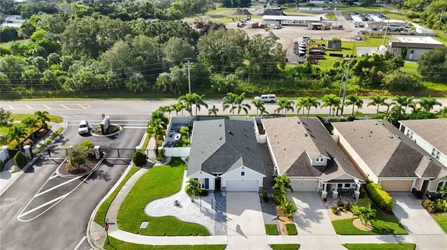 an aerial view of a house with garden space and street view
