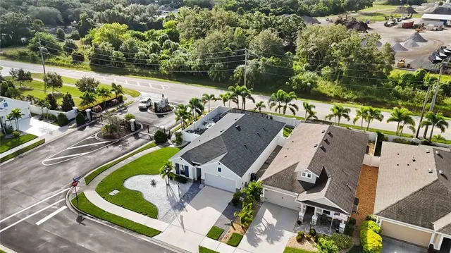 an aerial view of a house with a yard basket ball court and outdoor seating