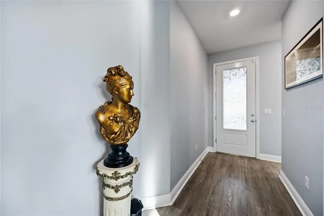 a room with a window wooden floor and a chandelier
