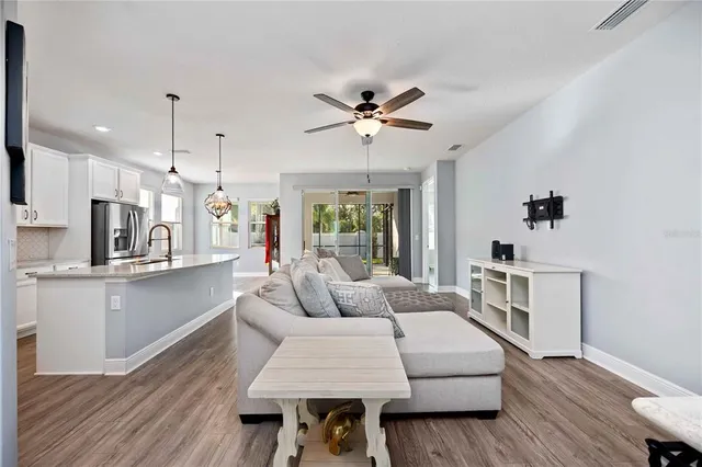 a living room with kitchen island furniture and a wooden floor
