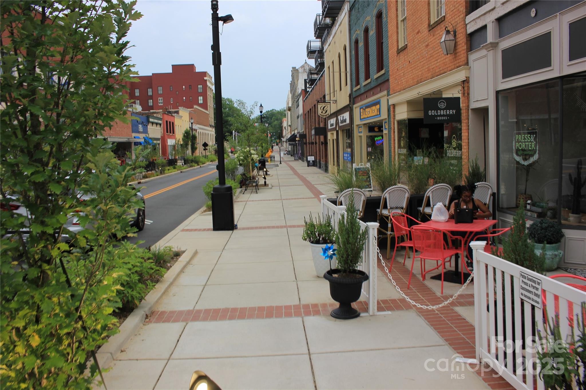 571 Union Street South Concord, NC 28025 - Photo 29 of 34 a view of a patio with dining table and chairs potted plants