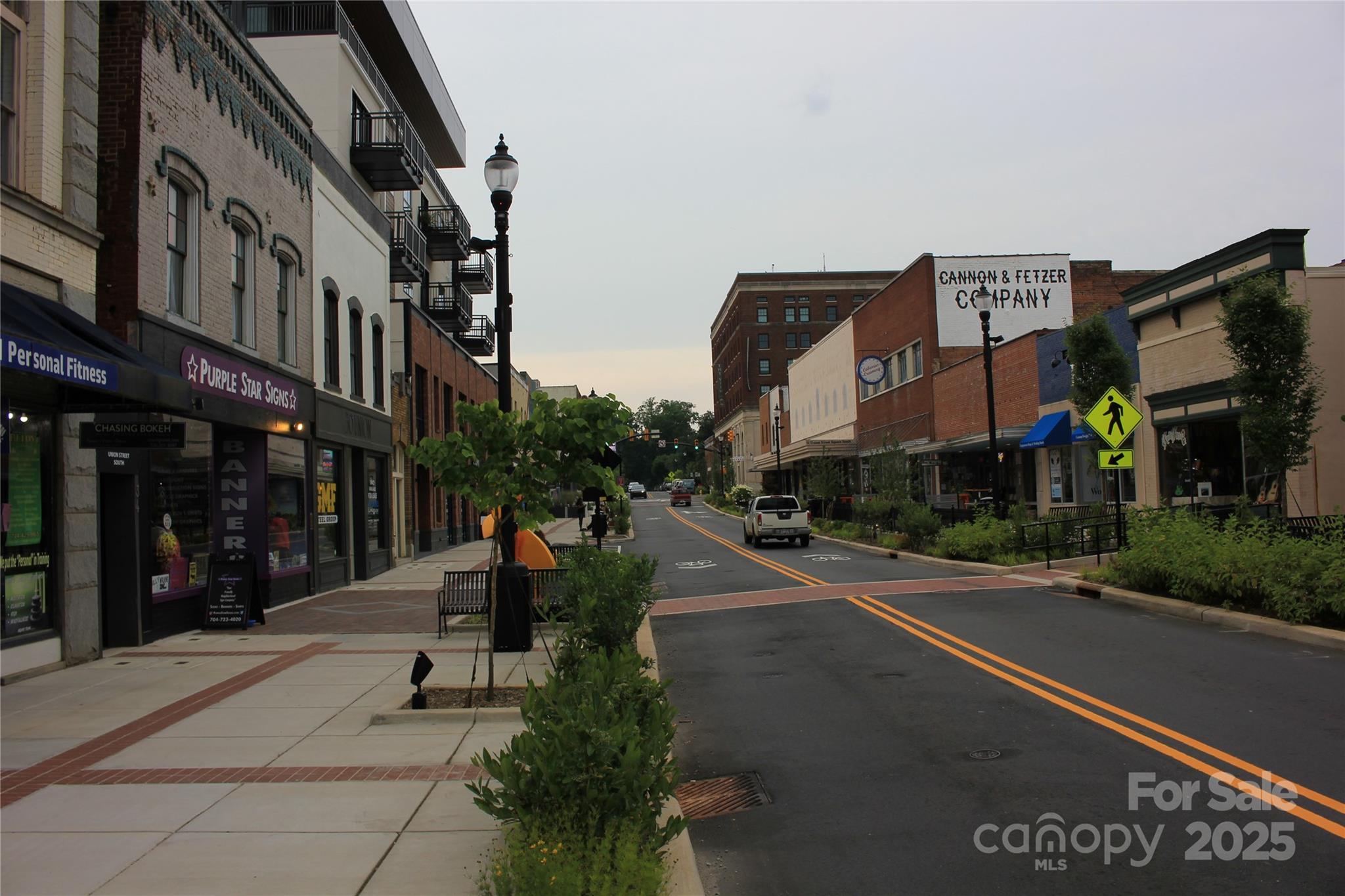 571 Union Street South Concord, NC 28025 - Photo 33 of 34 a city street lined with tall buildings