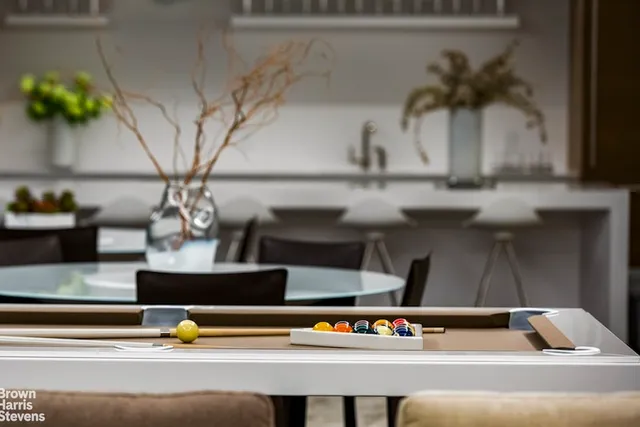 a vase of flowers sitting on a table with a potted plant