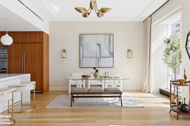 a kitchen with a sink and a stove with wooden floor
