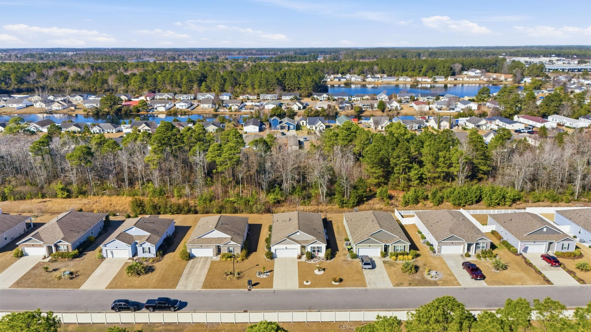 144 Legends Village Loop Myrtle Beach, SC 29579 - Photo 25 of 25 Aerial perspective of suburban area featuring a tree filled landscape