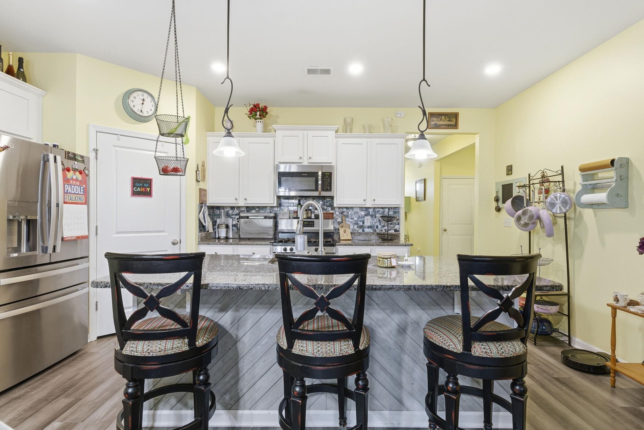 144 Legends Village Loop Myrtle Beach, SC 29579 - Photo 4 of 25 Kitchen with stainless steel appliances, backsplash, dark stone countertops, white cabinets, and recessed lighting