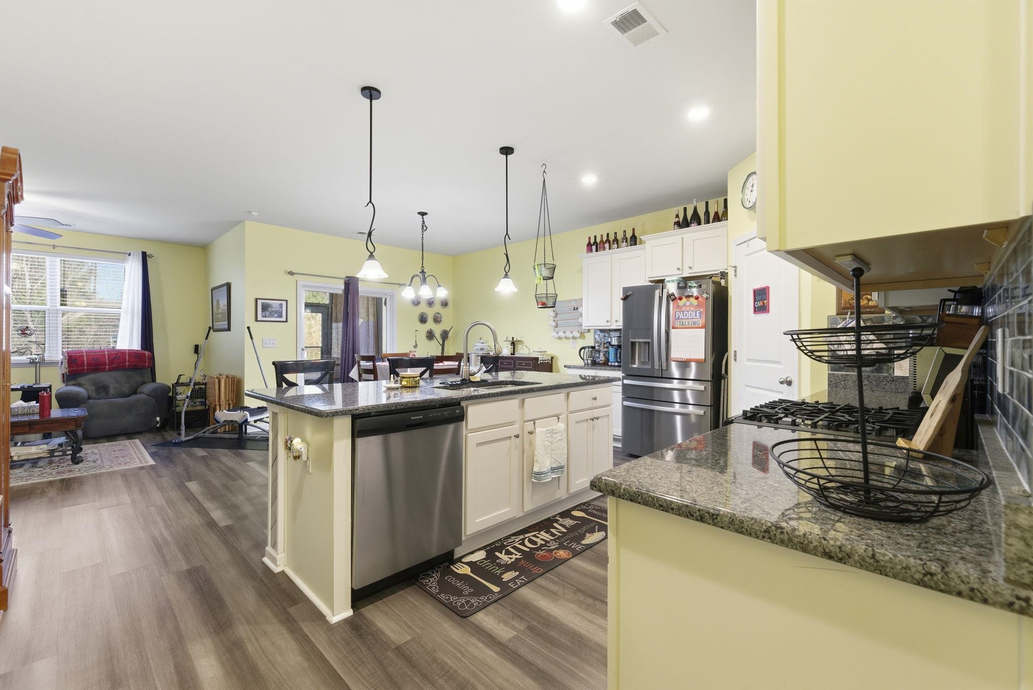 144 Legends Village Loop Myrtle Beach, SC 29579 - Photo 7 of 25 Kitchen featuring dark stone countertops, stainless steel appliances, hanging light fixtures, dark wood-type flooring, and recessed lighting