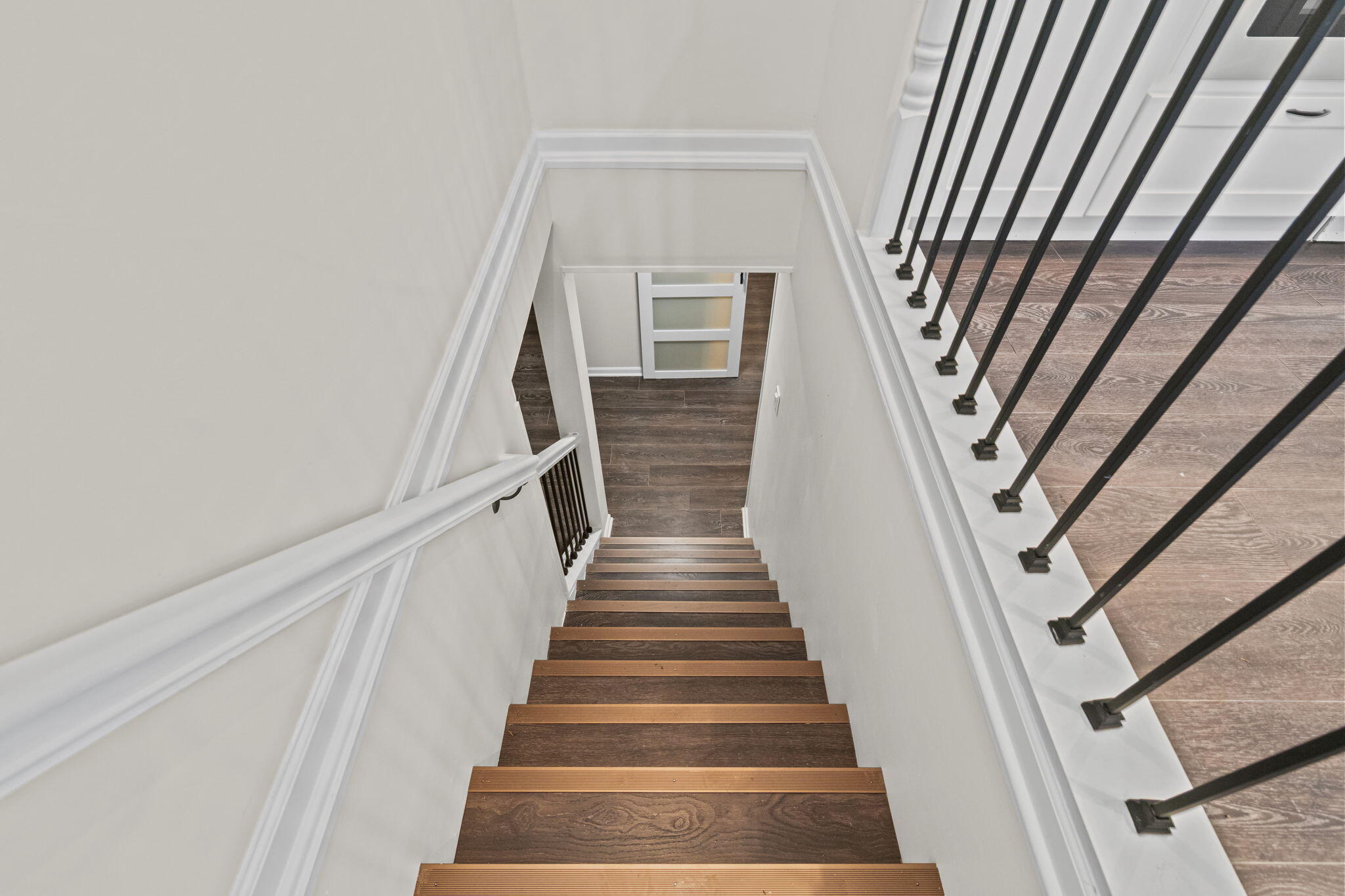 560 Free Church Drive Williams Bay, WI 53191 - Photo 16 of 28 Staircase down to the lower level upon entry at the garage side to the east.