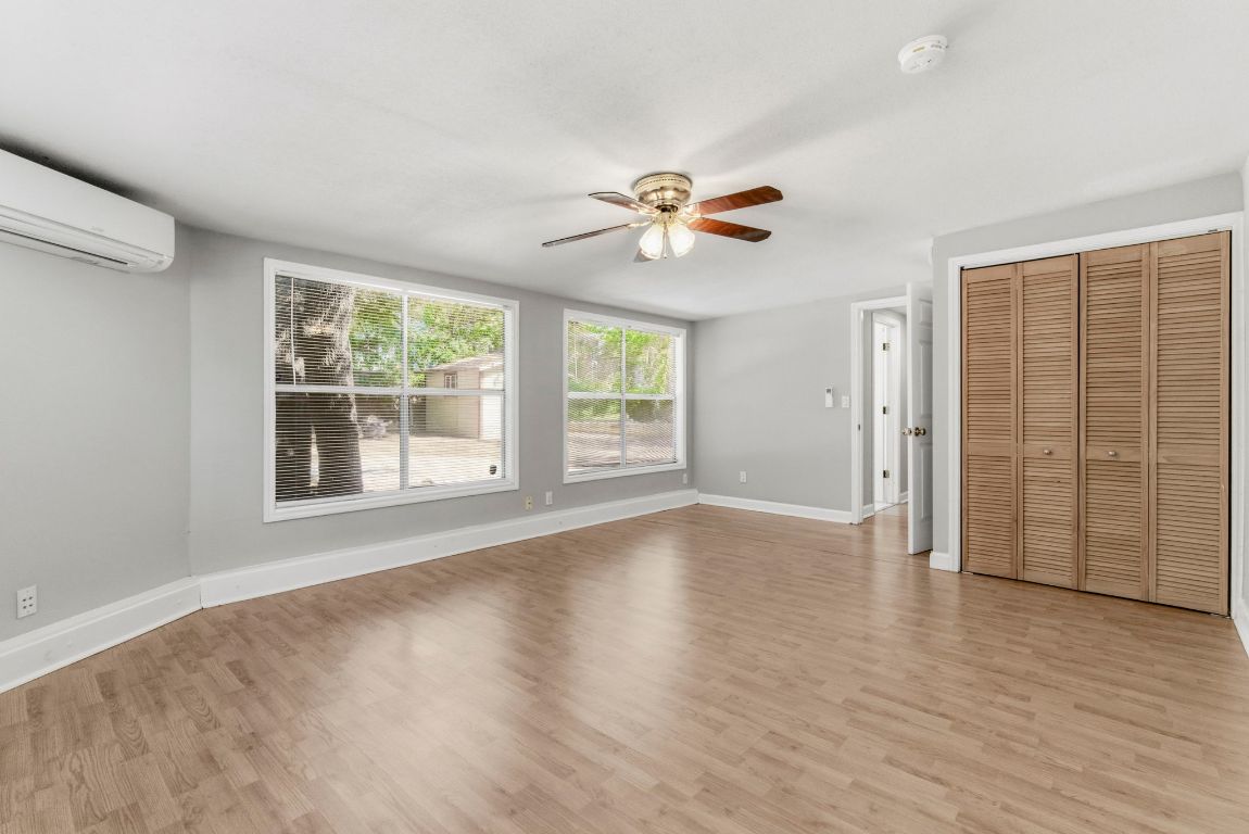1504 West 39th 1/2 Street Austin, TX 78756 - Photo 12 of 23 a view of an empty room with a window and wooden floor